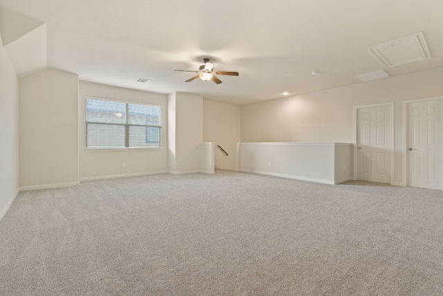 empty room with ceiling fan and light carpet