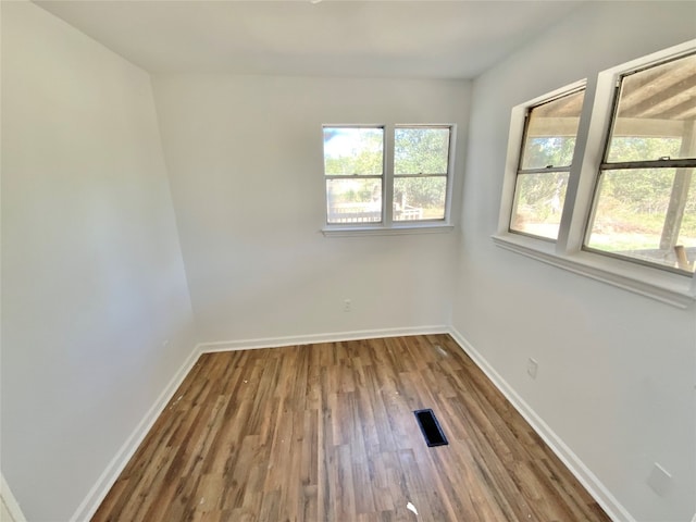 spare room with hardwood / wood-style floors