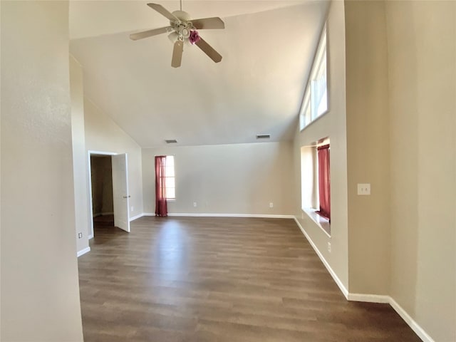 unfurnished living room featuring dark hardwood / wood-style flooring, high vaulted ceiling, and ceiling fan