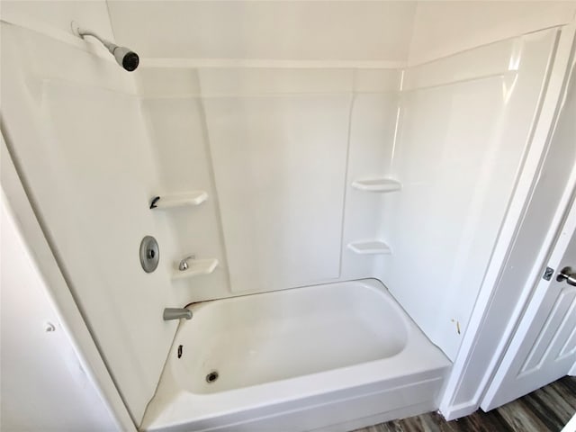 bathroom featuring shower / bath combination and hardwood / wood-style flooring