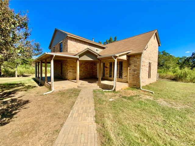 view of front facade with a patio area and a front yard