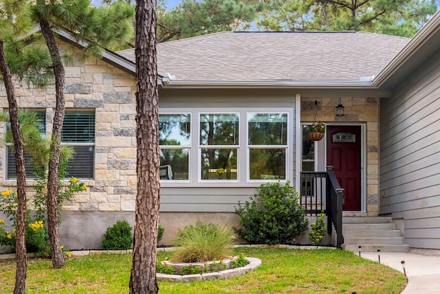 doorway to property featuring a lawn