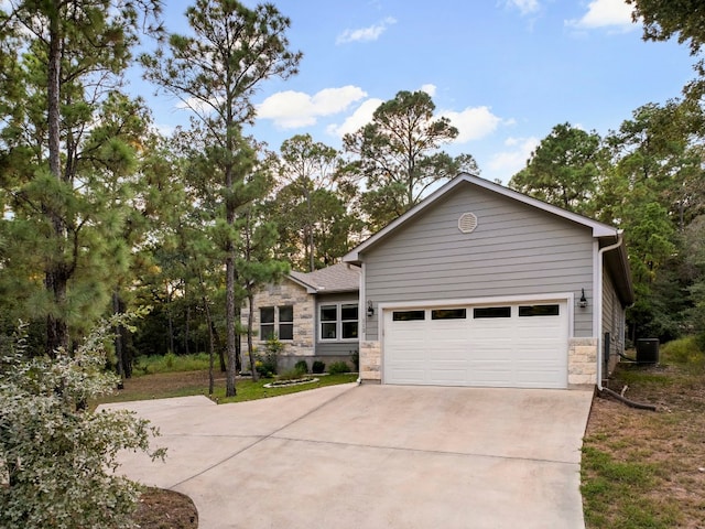 view of front facade featuring cooling unit and a garage