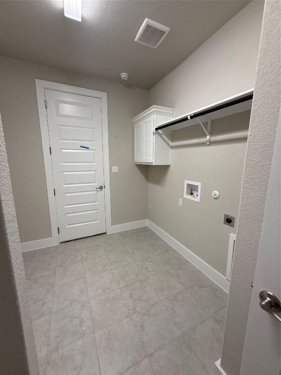 washroom featuring hookup for an electric dryer, cabinets, and hookup for a washing machine