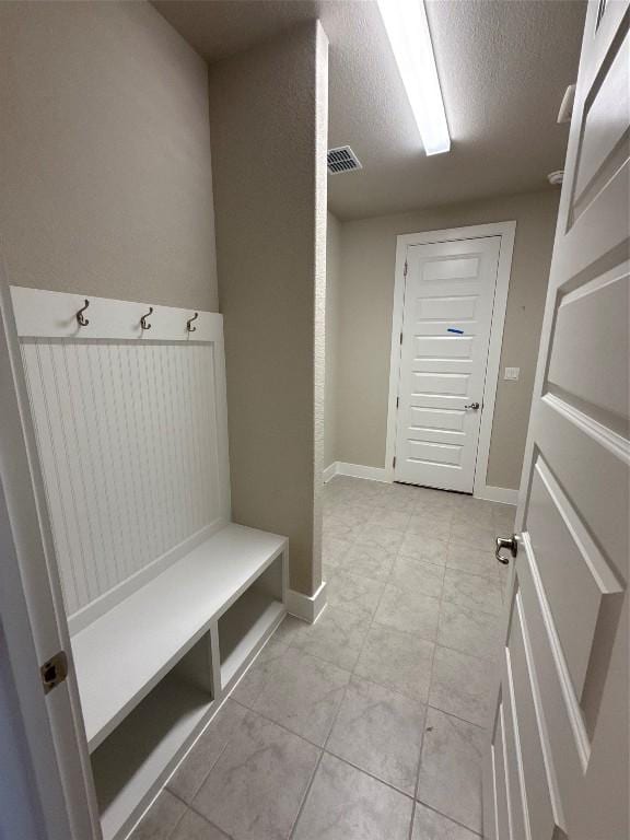 mudroom featuring a textured ceiling