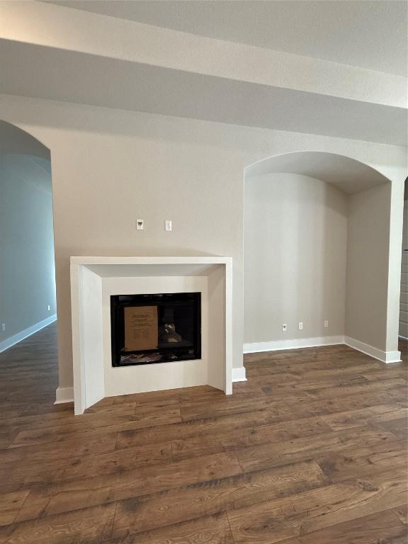 unfurnished living room featuring dark hardwood / wood-style floors