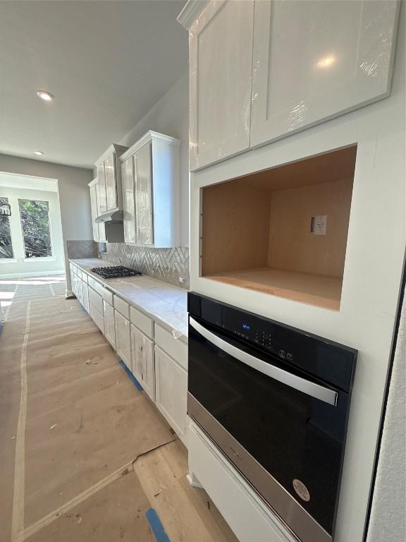 kitchen with white cabinetry and stainless steel appliances