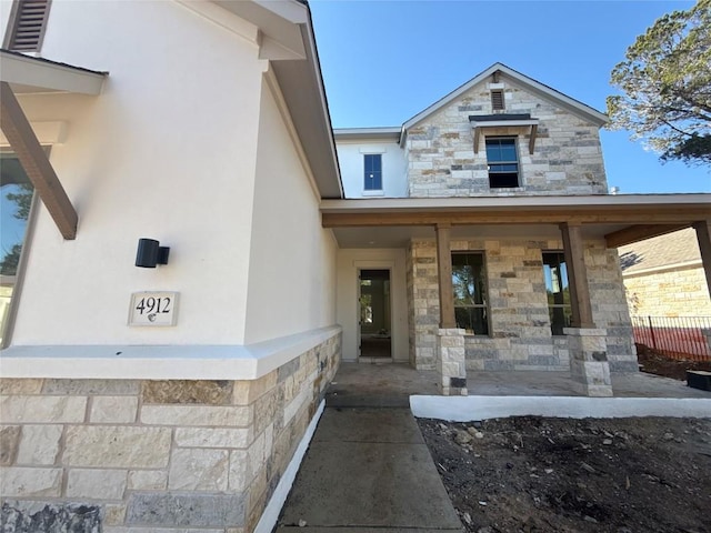 view of exterior entry with a porch