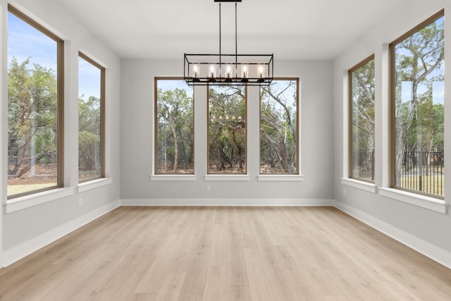 unfurnished sunroom featuring a chandelier