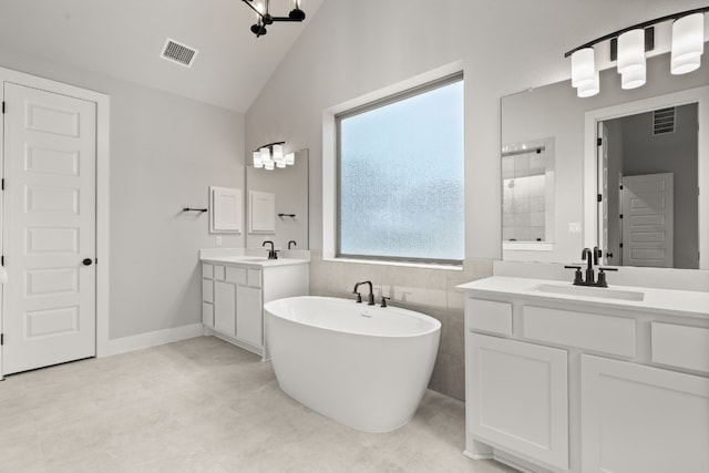 bathroom with vanity, vaulted ceiling, shower with separate bathtub, and tile walls