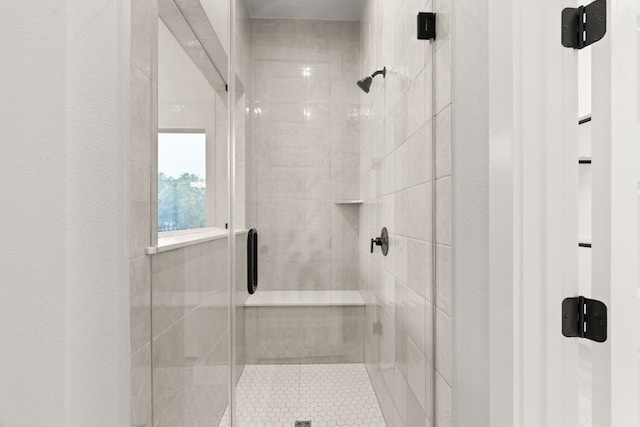 bathroom featuring a shower with door