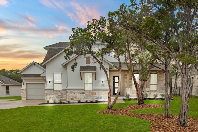 view of front of home featuring a yard and a garage