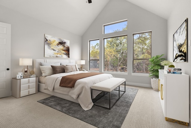 carpeted bedroom with ceiling fan and high vaulted ceiling