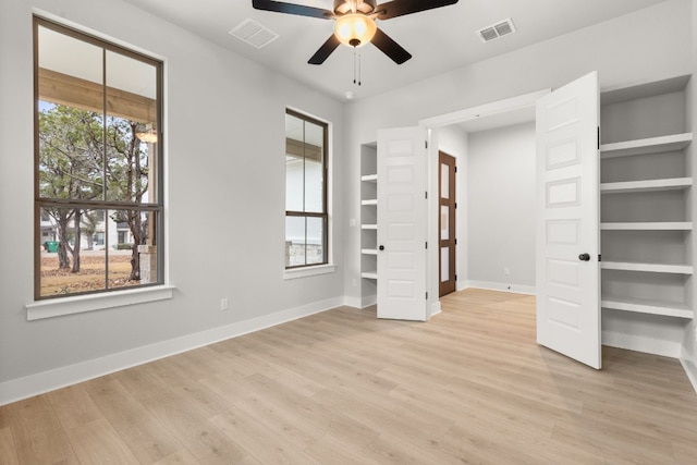 unfurnished bedroom featuring multiple windows, ceiling fan, and light hardwood / wood-style flooring