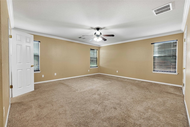 unfurnished room with ceiling fan, a textured ceiling, crown molding, and carpet flooring