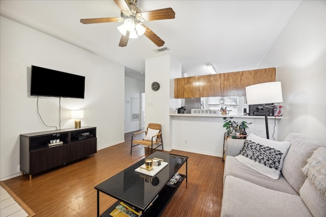 living room featuring ceiling fan and hardwood / wood-style floors