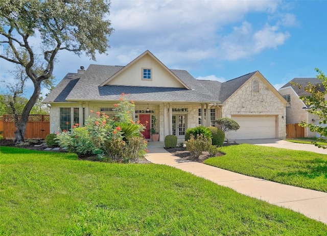 view of front of property featuring a garage and a front lawn