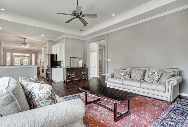 living room featuring ceiling fan, crown molding, and dark hardwood / wood-style flooring