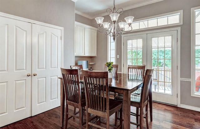 dining area with dark hardwood / wood-style flooring, crown molding, and a chandelier