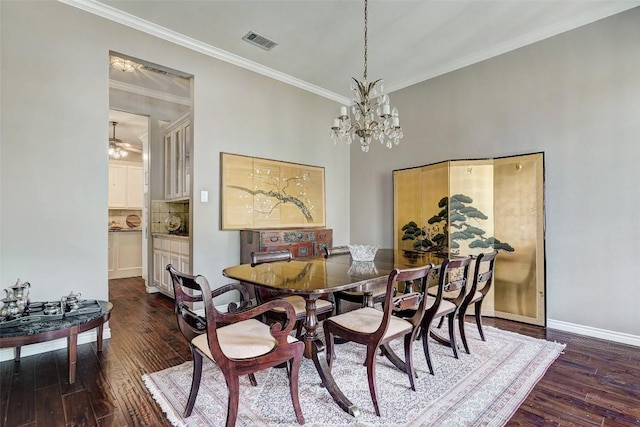 dining space featuring dark hardwood / wood-style flooring, crown molding, and a chandelier