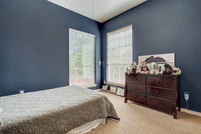 bedroom with light colored carpet and access to outside