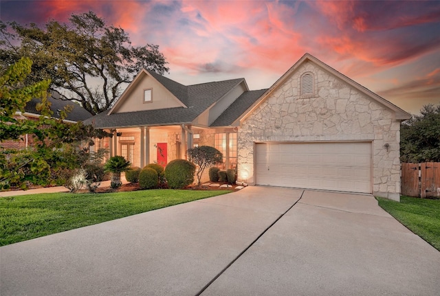 view of front facade featuring a garage and a yard