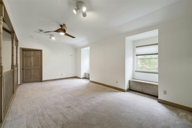 carpeted spare room with ceiling fan