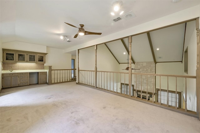 carpeted empty room featuring lofted ceiling and ceiling fan