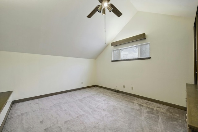 bonus room with light carpet, lofted ceiling, and ceiling fan