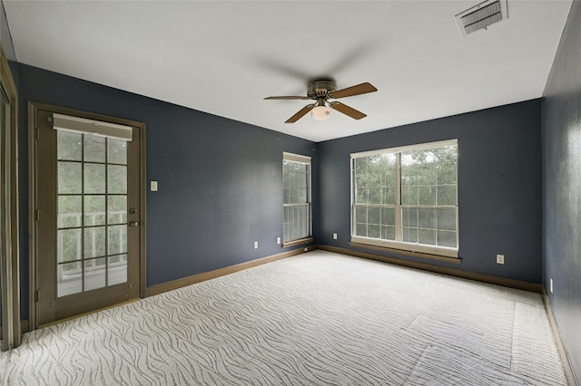 carpeted empty room featuring ceiling fan