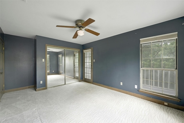 unfurnished bedroom with ceiling fan and carpet floors