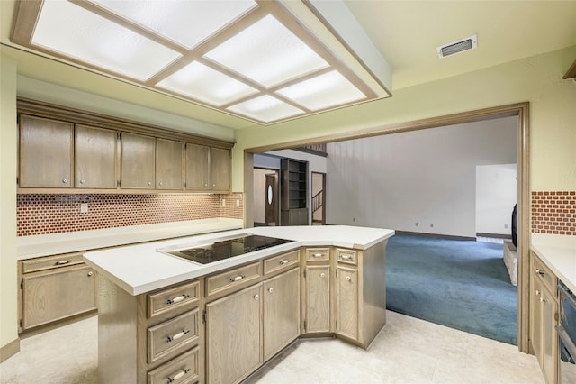 kitchen featuring black electric stovetop, backsplash, a kitchen island, and light carpet