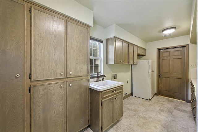 kitchen with sink and white fridge