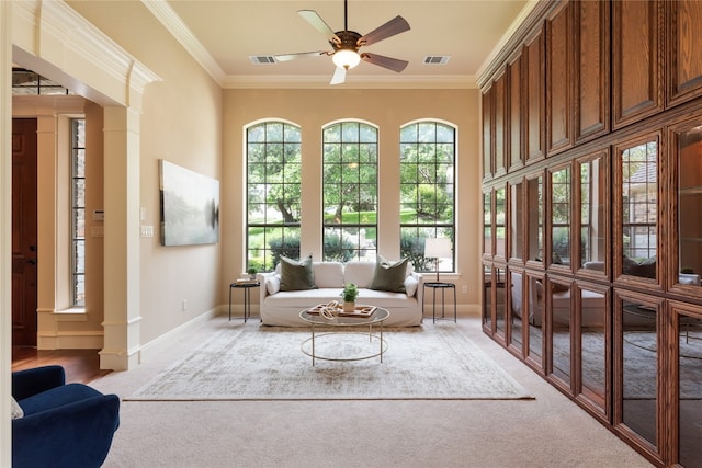 sitting room with ornamental molding, light carpet, and ceiling fan