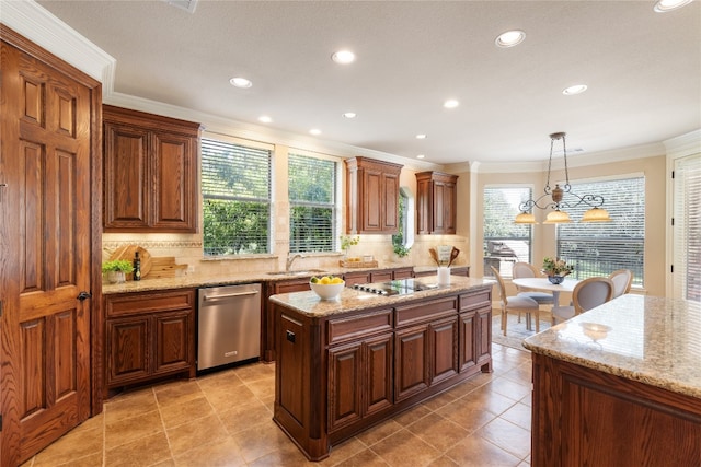 kitchen with decorative light fixtures, appliances with stainless steel finishes, a wealth of natural light, and a center island