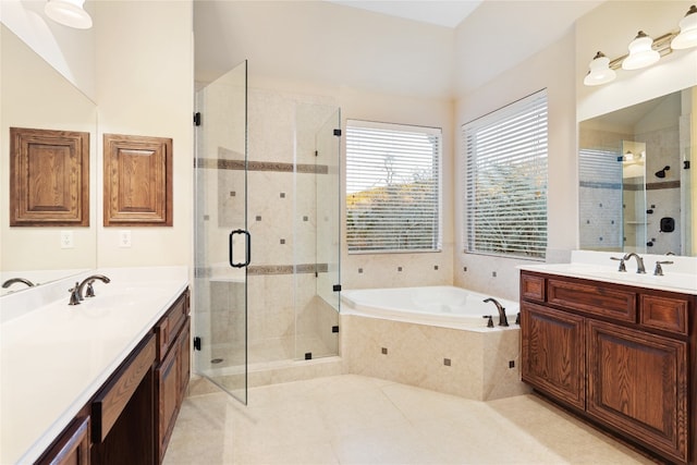 bathroom featuring independent shower and bath, vanity, and tile patterned floors