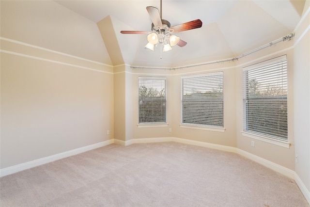 carpeted spare room with ceiling fan and lofted ceiling