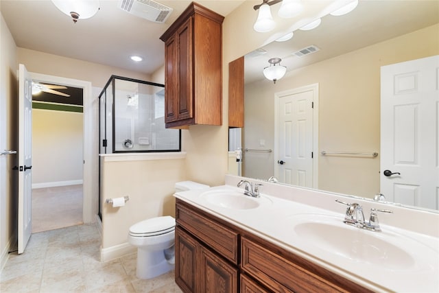 bathroom with a shower with shower door, vanity, tile patterned flooring, ceiling fan, and toilet