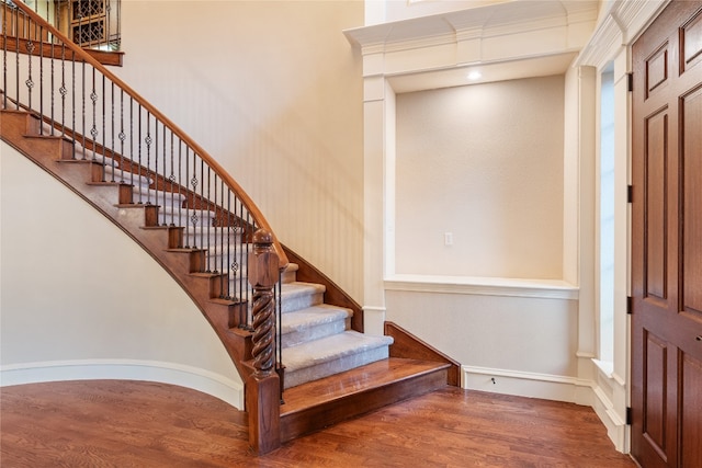 stairs with hardwood / wood-style flooring