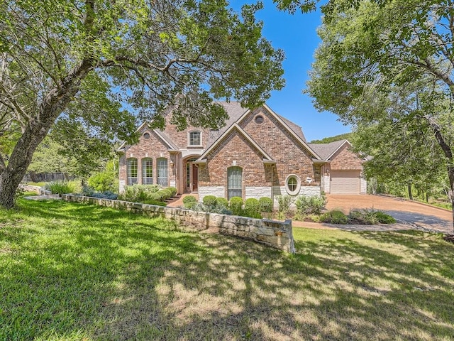 view of front facade with a front yard and a garage