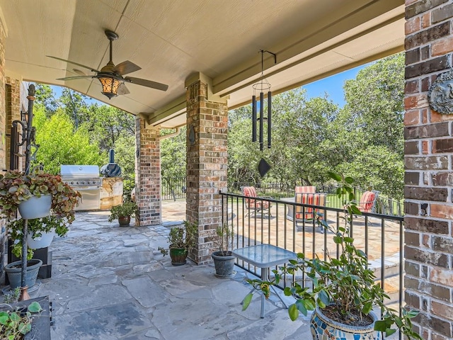 view of patio with area for grilling, ceiling fan, and exterior kitchen