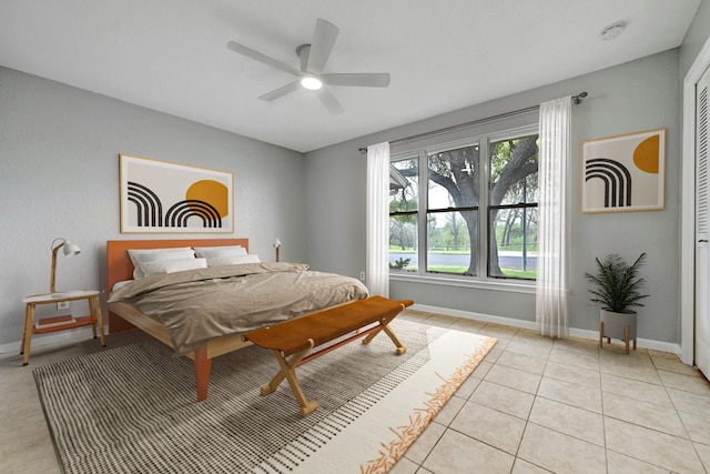 bedroom with a closet, ceiling fan, and light tile patterned flooring