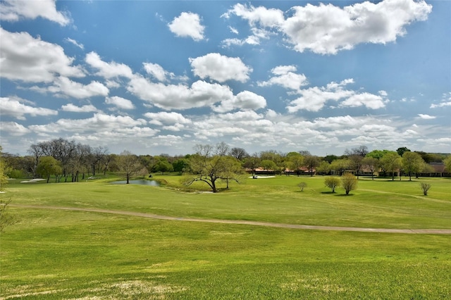 view of community featuring a lawn and a water view