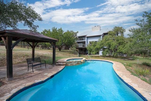 view of pool with an in ground hot tub and a gazebo