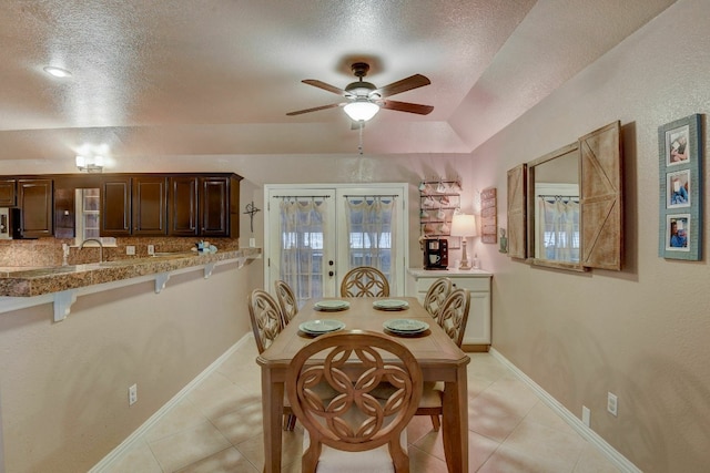 dining room with french doors, a textured ceiling, ceiling fan, and light tile patterned flooring