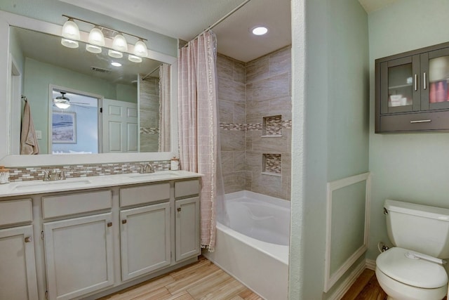 full bathroom with ceiling fan, shower / bath combination with curtain, toilet, decorative backsplash, and hardwood / wood-style flooring