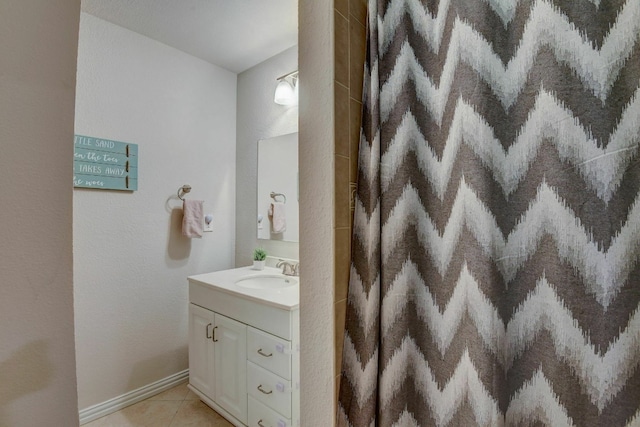 bathroom featuring tile patterned flooring and vanity