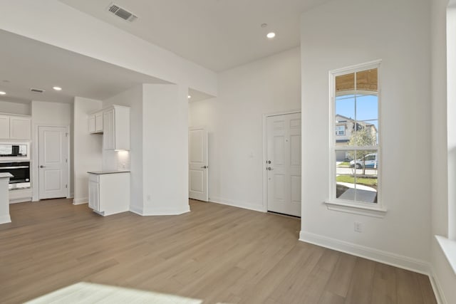 unfurnished living room with light wood-type flooring