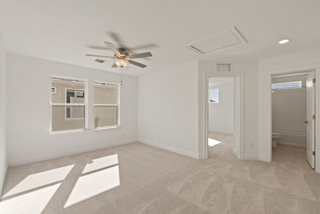 unfurnished bedroom featuring ensuite bath, ceiling fan, and light colored carpet