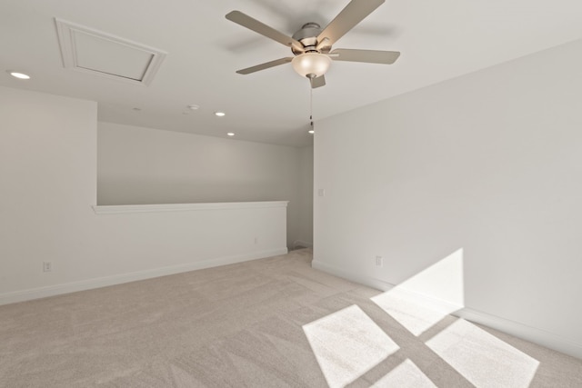 spare room with ceiling fan and light colored carpet